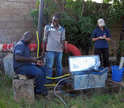 Sampling groundwater from a production well in Lusaka